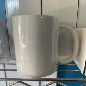 A white coffee mug sitting on top of a counter.