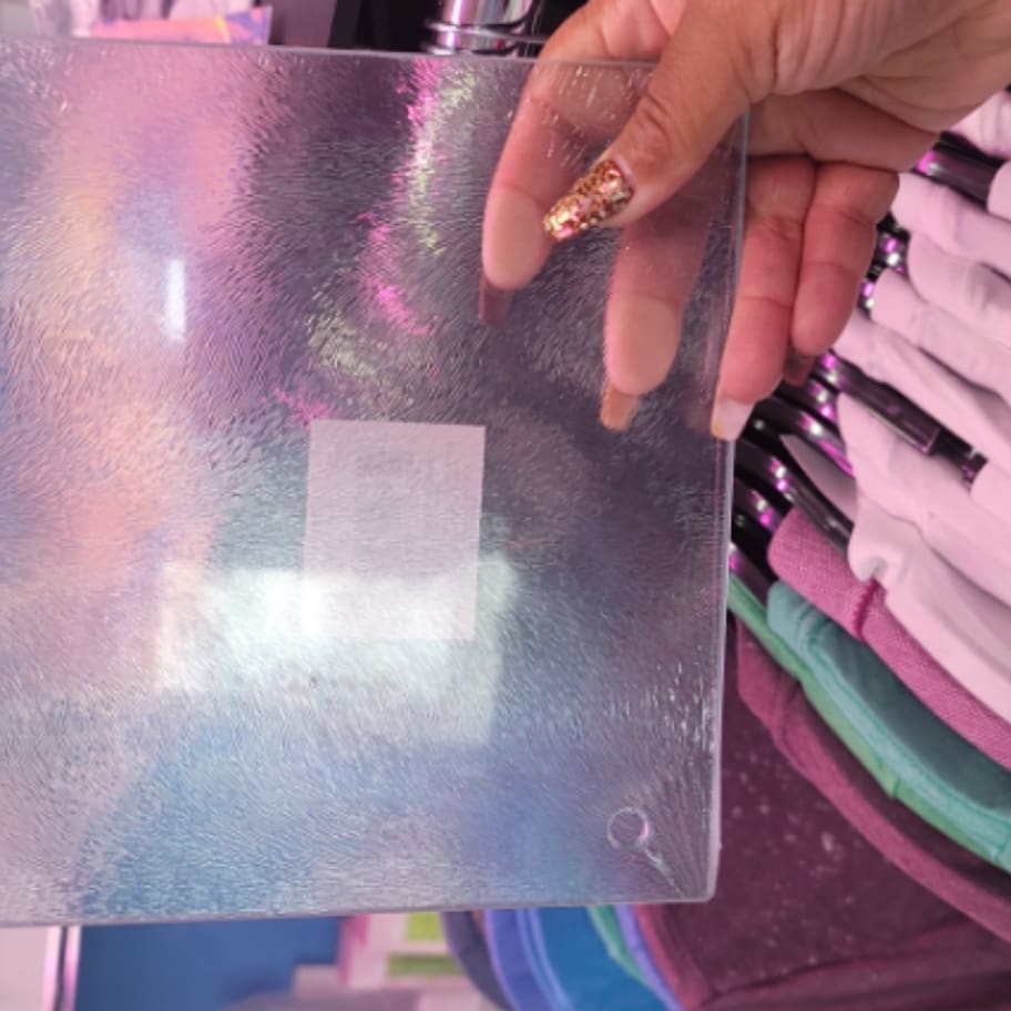 A person holding onto a sheet of plastic