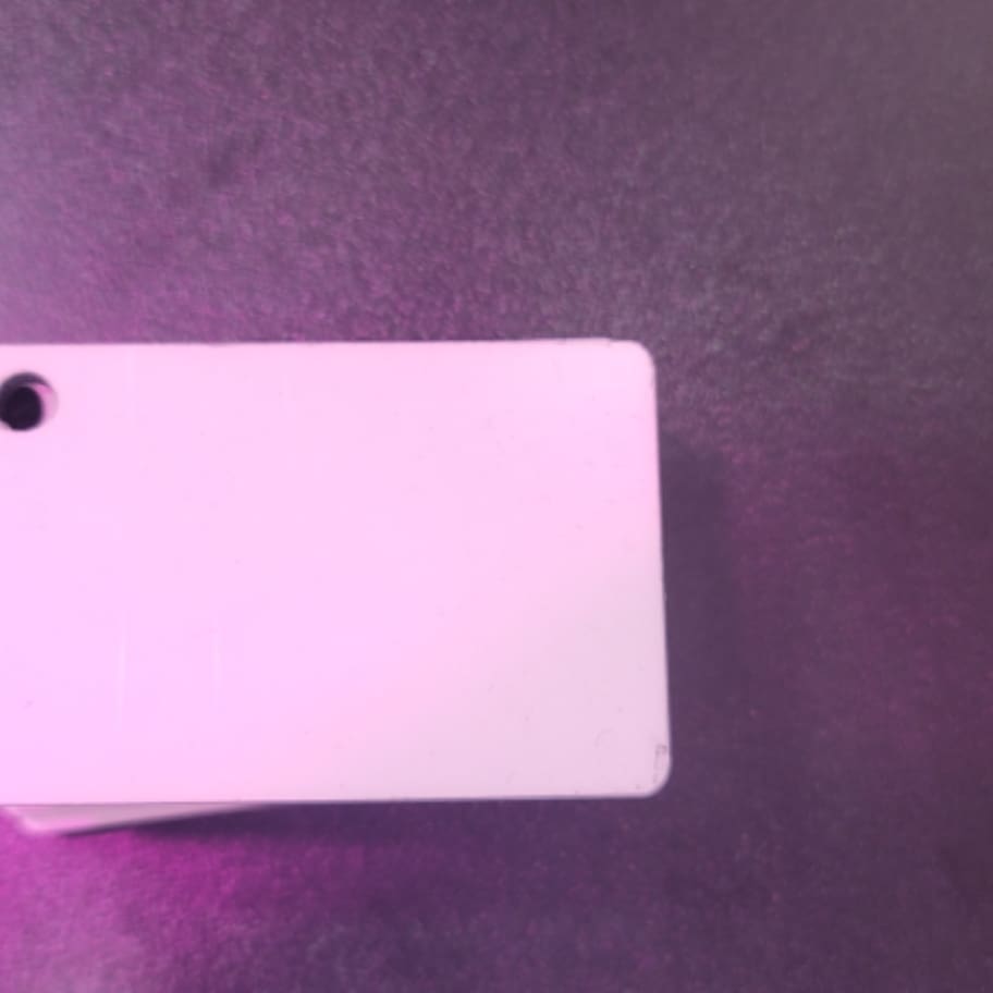 A white card sitting on top of a purple table.