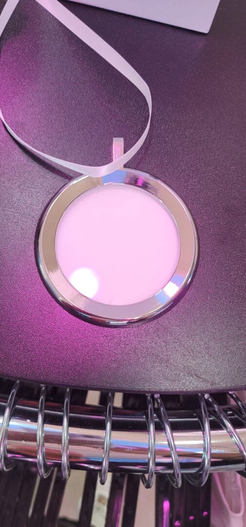 A pink and silver necklace on top of a table.